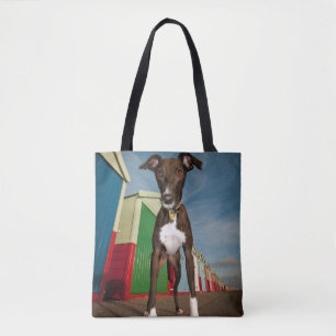 A Lurcher Standing In Front Of Some Beach Huts Tote Bag