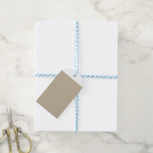 a man in a suit and tie standing in front of a wal gift tags