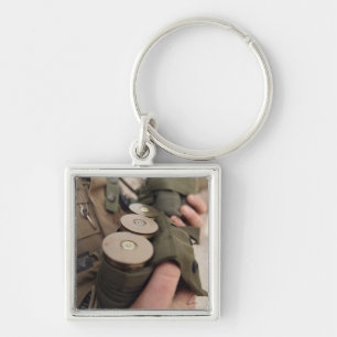 A Marine cradles handfuls of 40 mm grenades Key Ring