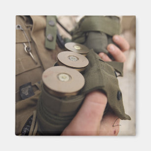 A Marine cradles handfuls of 40 mm grenades Magnet