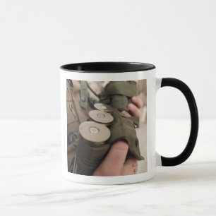 A Marine cradles handfuls of 40 mm grenades Mug