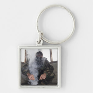 A marine fills the gas chamber with more CS gas Key Ring