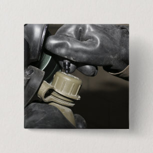 A Marine inserts a drinking tube into his cante 15 Cm Square Badge