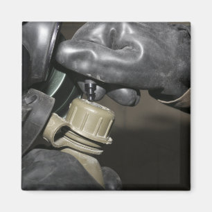 A Marine inserts a drinking tube into his cante Magnet
