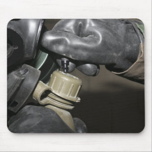 A Marine inserts a drinking tube into his cante Mouse Mat