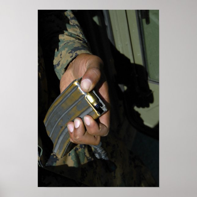 A Marine loads blank ammunition rounds Poster (Front)