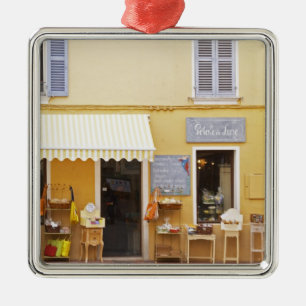 A market street in the old town with a shop metal tree decoration