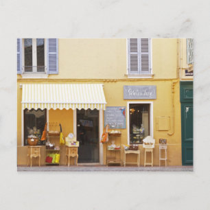 A market street in the old town with a shop postcard