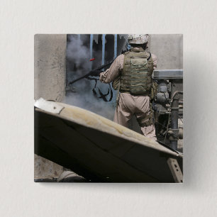 A military policeman uses a breaching round 15 cm square badge