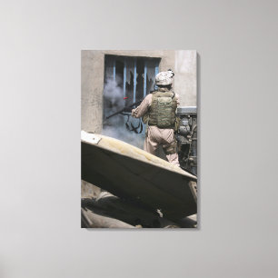 A military policeman uses a breaching round canvas print