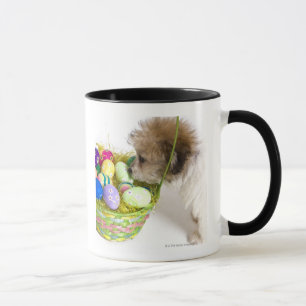 A mixed breed puppy sniffing at an Easter basket Mug