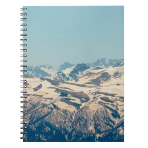 A mountain range with thawing snow and ice in the notebook