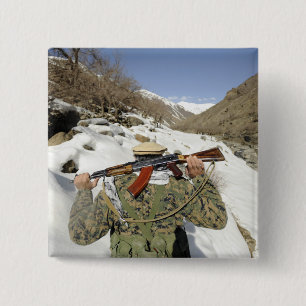 A Mujahadeen Guard walks with US Military membe 15 Cm Square Badge