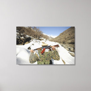 A Mujahadeen Guard walks with US Military membe Canvas Print