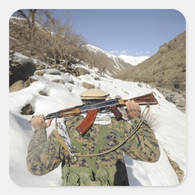 A Mujahadeen Guard walks with US Military membe Square Sticker (Front)