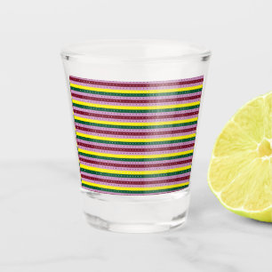 a multicolored striped background with dots shot glass