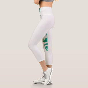 a painting of a flower and a fish on a black backg capri leggings