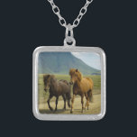 A Pair of Brown Icelandic Ponies Silver Plated Necklace<br><div class="desc">A totally cute and adorable photo capture of 2 icelandic ponies trotting down a dirt road. One is a bay and the other is chestnut coloured. Their gorgeous manes blowing in the wind. A beautiful mountain landscape can be seen in the background and adds a sense of wonder to this...</div>