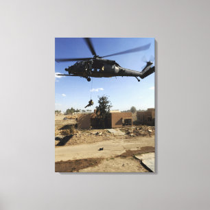 A pararescueman rappels from an HH-60 2 Canvas Print