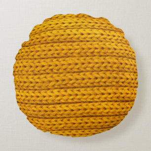 A pattern of yellow knitted fabric of yarn. round cushion