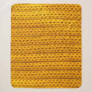 A pattern of yellow knitted fabric of yarn. sherpa blanket