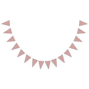 A patterned rug with red and brown motifs lies on bunting