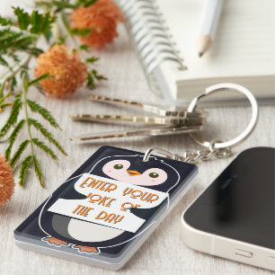 A penguin holding a sign with custom text key ring