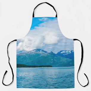 A peninsula of land covered in pine forest juts ou apron