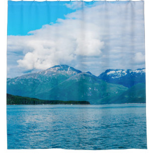 A peninsula of land covered in pine forest juts ou shower curtain