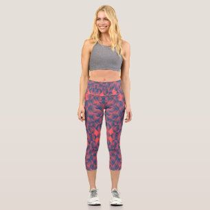A person wearing high-waisted, geometric-patterned capri leggings