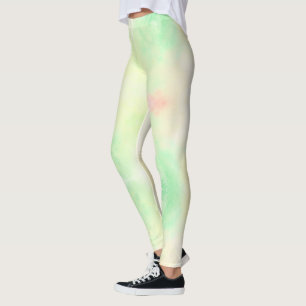 A person wearing pastel green leggings with pink