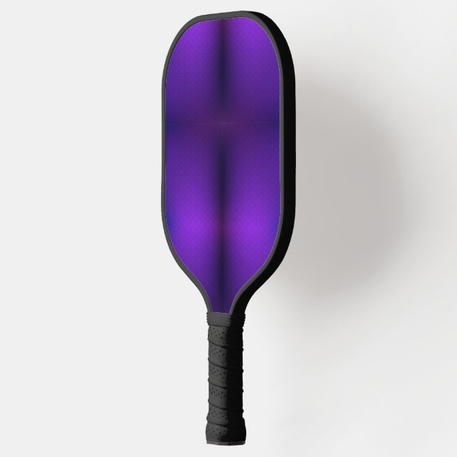 A pickleball paddle is shown against a white  (Left)