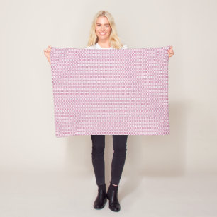 a pink and white background with wavy lines fleece blanket