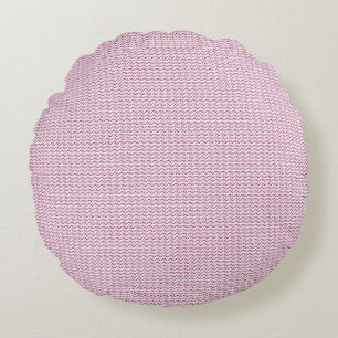 a pink and white background with wavy lines round cushion