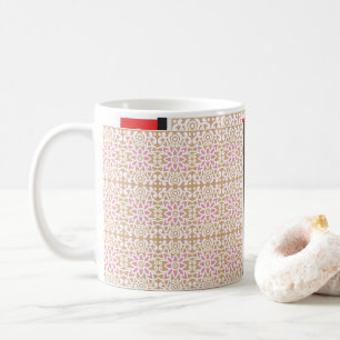 a pink and white flower pattern on a brown backgro coffee mug