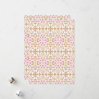 a pink and white flower pattern on a brown backgro