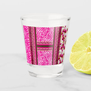 a pink and white wallpaper with a cross on it shot glass