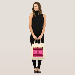 a pink and white wallpaper with a cross on it tote bag