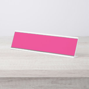 a pink background with a black border desk name plate
