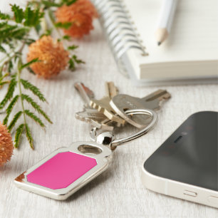 a pink background with a black border key ring