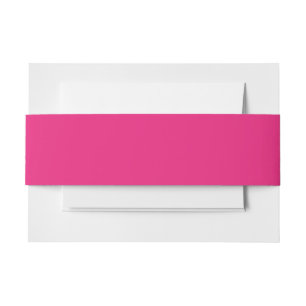 a pink background with a black invitation belly band