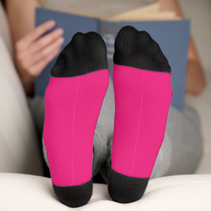 a pink background with a black socks