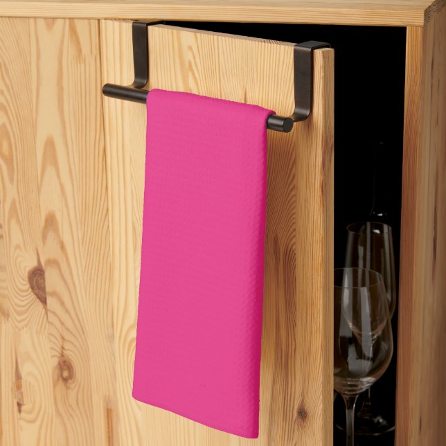 a pink background with a black tea towel (Thirds Fold)