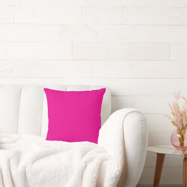 a pink background with a  cushion (Couch)