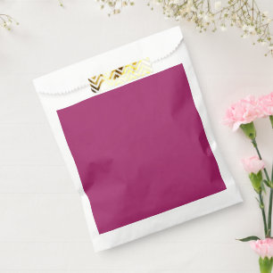 a pink background with a white favour bags