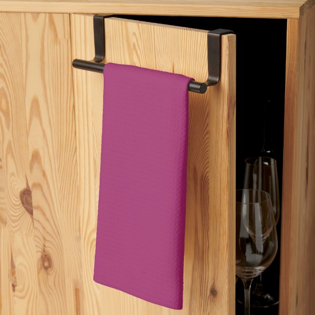 a pink background with a white tea towel (Thirds Fold)