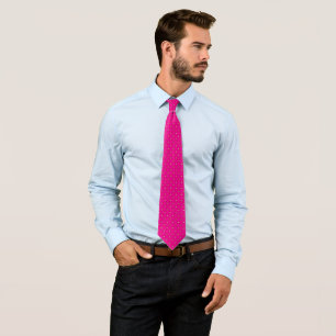 a pink background with white polka dots tie