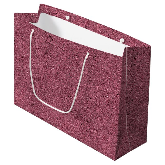 A pink glitter gift bag with a white handle (Front Angled)