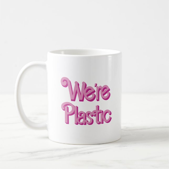 A pink We’re Plastic Coffee Mug (Left)