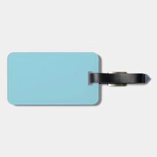 A plain light blue background fills the image luggage tag